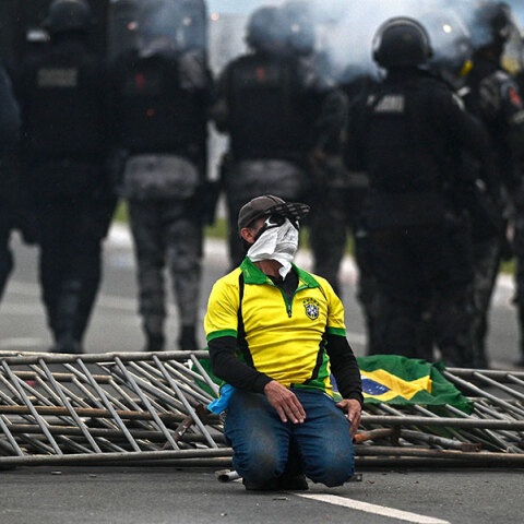 Υποστηρικτής του Μπολσονάρου ανάμεσα σε αστυνομικούς μετά την εισβολή στο Κογκρέσο στην πρωτεύουσα της Βραζιλίας
