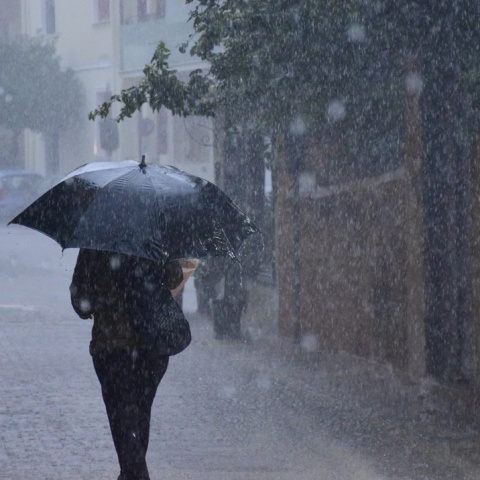 Άτομο με ομπρέλα εν μέσω ισχυρής καταιγίδας