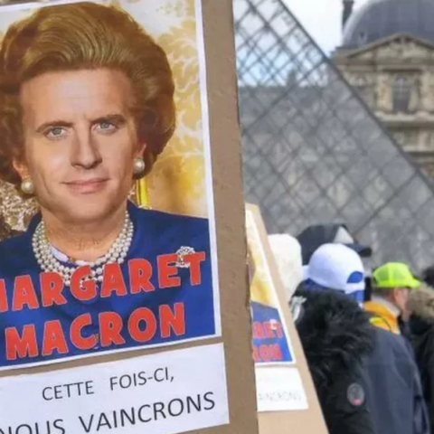 Αφίσα με τον Εμανουέλ Μακρόν ως Μάργκαρετ Θάτσερ έξω από το Λούβρο