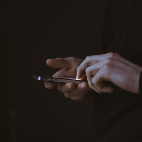 Χέρια πληκτρολογούν σε τηλέφωνο