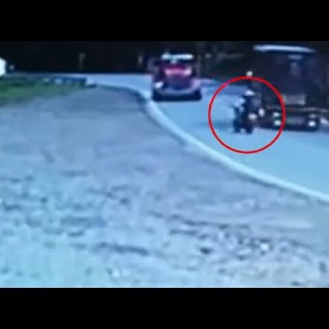 Biker tries to take over truck only to smash into an oncoming truck