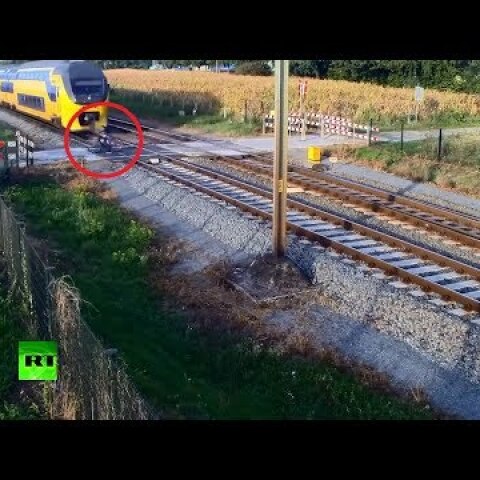 Cheating death: Train sweeps behind Dutch cyclist who didn't see it coming