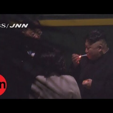 Kim Jong-un puffs on cigarette on train station platform in China