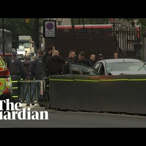 Westminster car crash: handcuffed man taken away by police