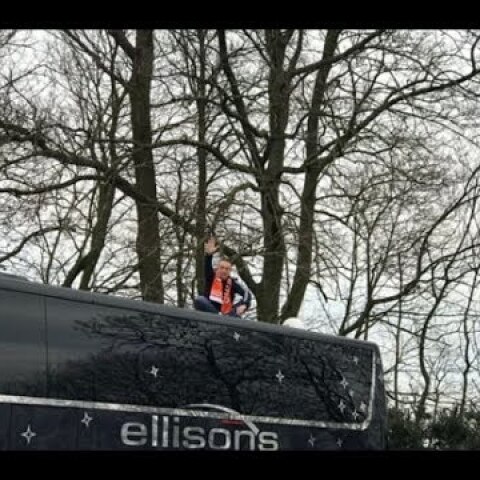Blackpool fan sits on top of Arsenal's bus in Oyston protest
