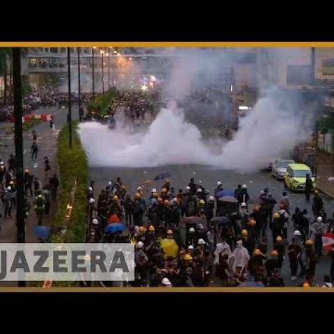 Hong Kong police draw guns, use water cannon in clashes