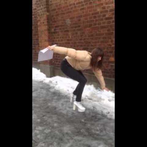 Lady with heels sliding down ice