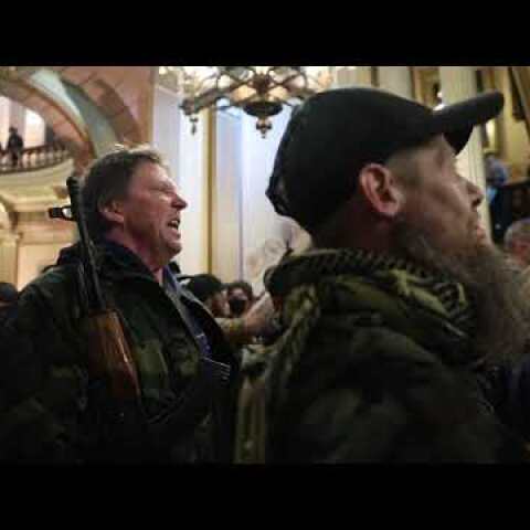 Protesters argue with police inside Michigan Capitol building