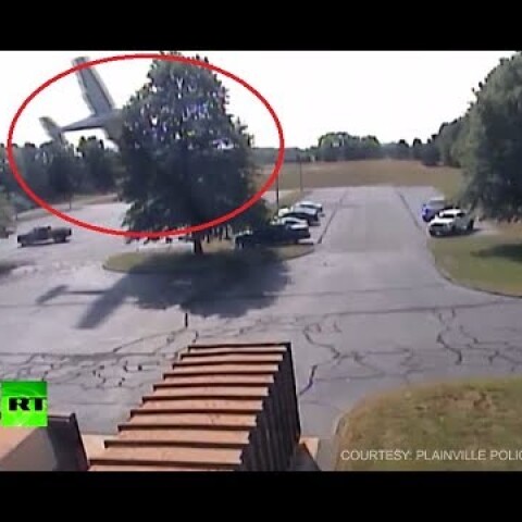 RAW: Moment plane crashes into tree in US parking lot caught on CCTV