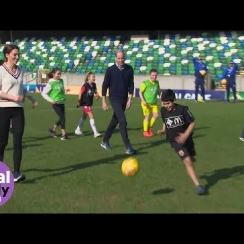 The Duke and Duchess of Cambridge join children on the pitch at Windsor Park, Belfast
