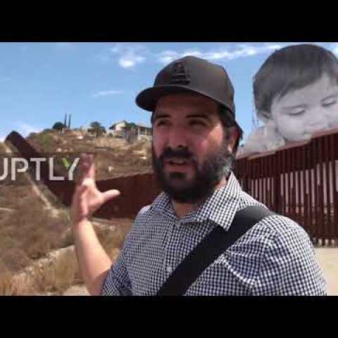 Mexico: Gigantic toddler peeks over Tecate border wall to see the other side