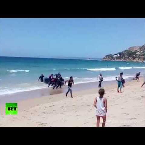 Storm on the beach: Spanish tourists shocked as dinghy full of migrants lands on shore