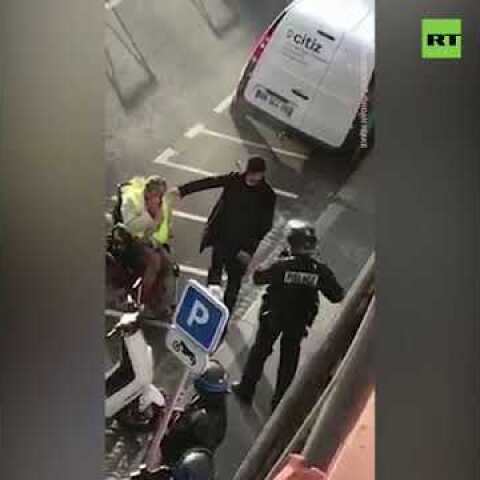 French police forces pepper spray a man in a wheelchair
