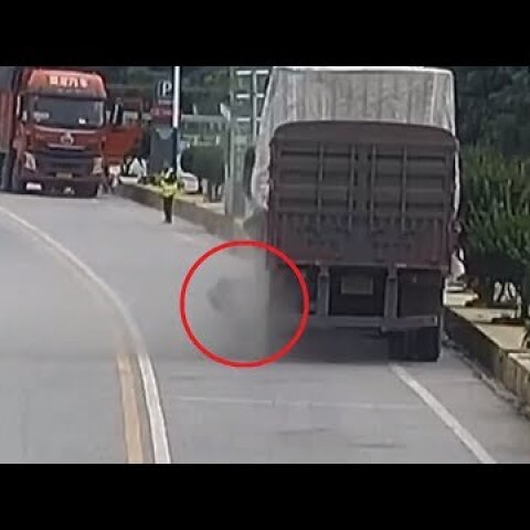 Moment truck tire explodes as Chinese driver tries to fix it (DISTURBING)