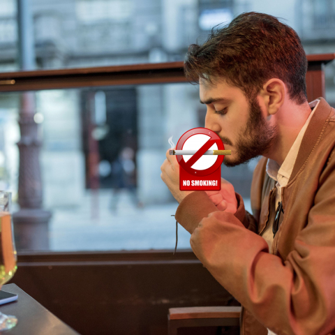 young-man-smoking-a-cigarillo-at-outdoor-bar-688029163-5a5082e2aad52b0036fa01ab_copy.jpg
