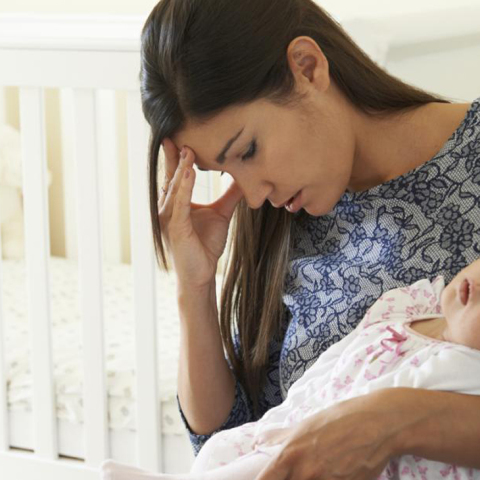 woman-with-postpartum-depression-holding-baby.jpg