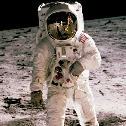 astronaut standing on gray sand