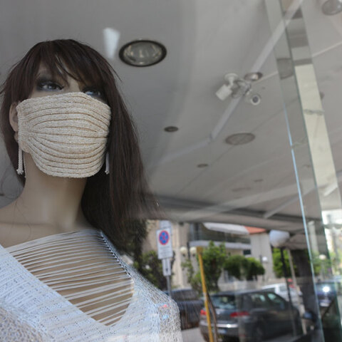 Κούκλα βιτρίνας καταστημάτων ρούχων με μάσκα λόγω κορωνοϊού