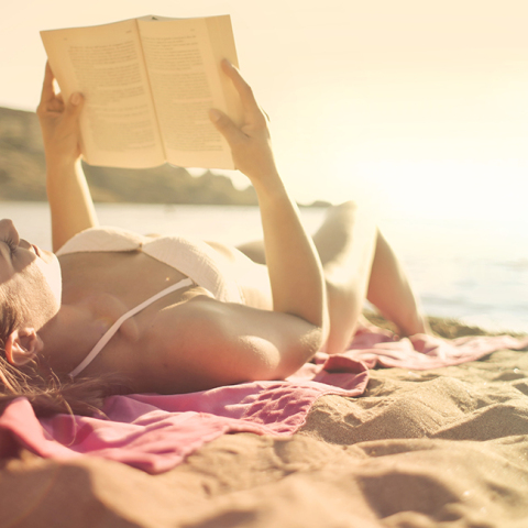 woman-lying-on-beach-reading-book.jpg