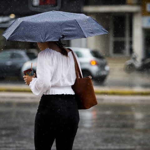 Κυρία με ομπρέλα στο κέντρο της Αθήνας