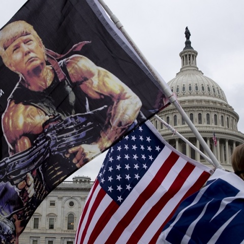 Οπαδός του Τραμπ έξω από τον Λευκό Οίκο με σημαία που απεικονίζει τον πρόεδρο των ΗΠΑ ως Ράμπο