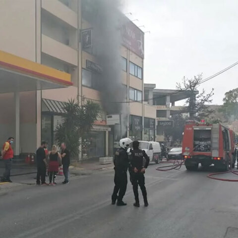 Νέα Ιωνία - Καλογρέζα: Πυροσβέστες και αστυνομικοί έξω από το συνεργείο αυτοκινήτων όπου ξέσπασε φωτιά