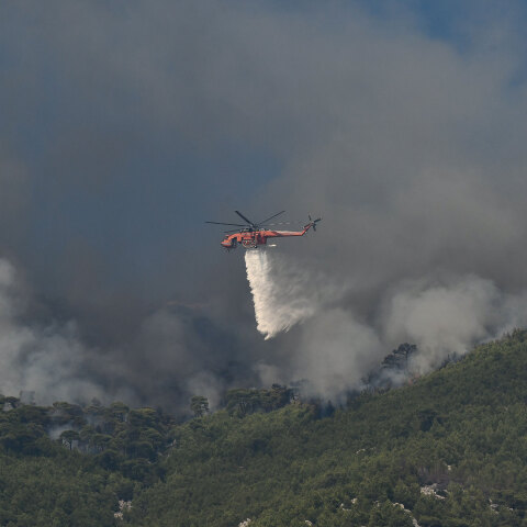 Μεγάλη φωτιά στην Κορινθία, με ελικόπτερο της Πυροσβεστικής να ρίχνει νερό πάνω από εστία της πυρκαγιάς που καίει το δάσος