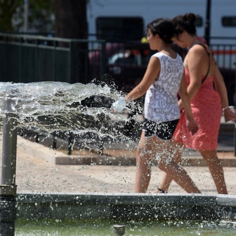 Καύσωνας - Γυναίκες περπατούν μπροστά από σιντριβάνι