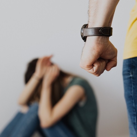 Μια γυναίκα σε αμυντική θέση. Μπροστά, διακρίνεται η σφιγμένη γροθιά ενός άντρα