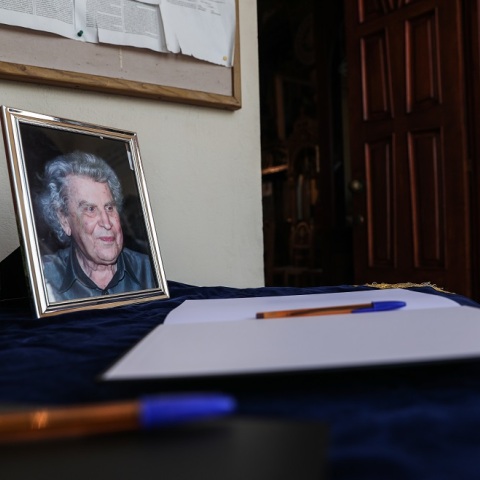 Mια φωτογραφία του Μίκη Θεοδωράκη με φόντο το βιβλίο συλληπτηρίων στην κηδεία του στα Χανιά Κρήτης