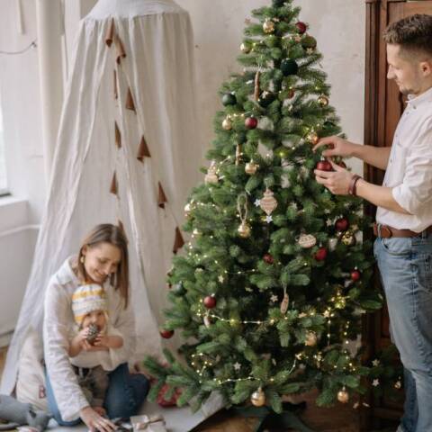 Οικογένεια στολίζει το χριστουγεννιάτικο δέντρο