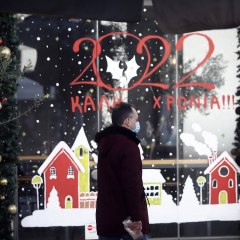 Άνδρας έξω από στολισμένη βιτρίνα μαγαζιού - Στιγμιότυπο από τη Θεσσαλονίκη την περίοδο των Χριστουγέννων 