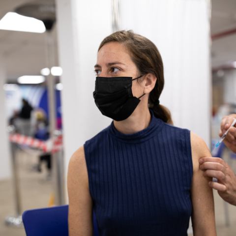 Woman receiving Covid-19 vaccine at a vaccination center/Getty Images/Ideal Image