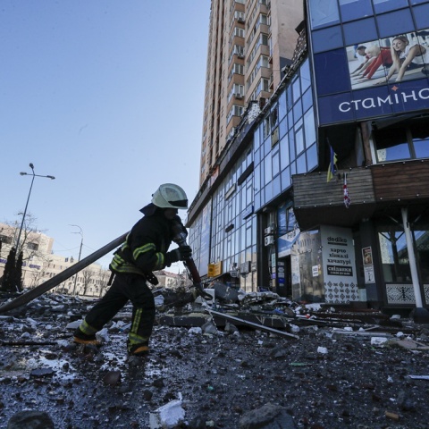 Πυροσβέστης στο Κίεβο κρατά μάνικα πατώντας σε συντρίμμια από βομβαρδισμούς