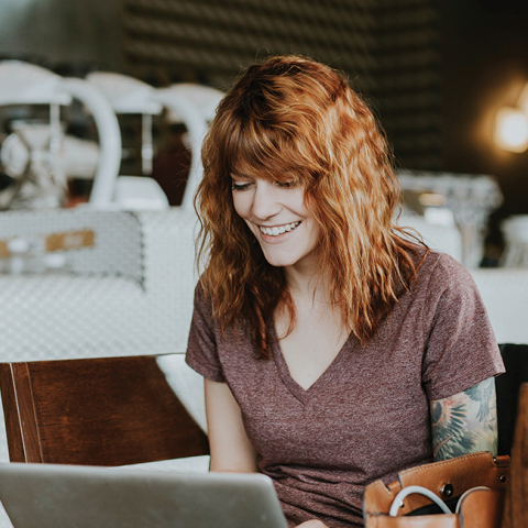 Γυναίκα που δουλεύει από το λάπτοπ της σε καφέ