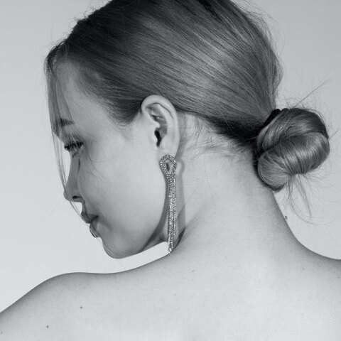 Ασπρόμαυρη φωτογραφία κοπέλας με πιασμένα μαλλιά σε χαμηλό κότσο