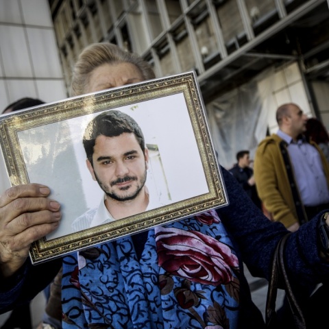 Φωτογραφία του Μάριου Παπαγεωργίου στα χέρια συγγενή του έξω από το δικαστήριο