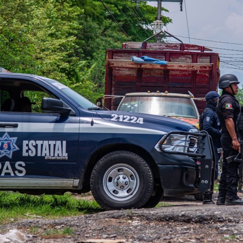 Αστυνομικός στέκεται έξω από περιπολικό όχημα σε δρόμο του Μεξικού