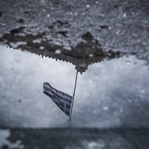 Αντανάκλαση της σημαίας στην Βουλή σε νερά βροχής