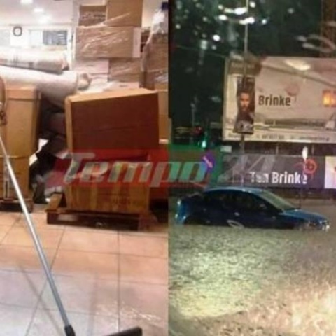 Πλημμυρισμένοι δρόμοι και άνδρας που προσπαθεί να διώξει τα νερά από την επιχείρησή του