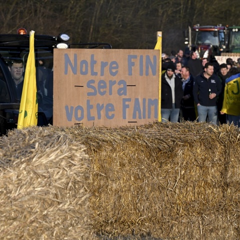 Αγρότες με παραταγμένα τα τρακτέρ τους και σανό σε δρόμο
