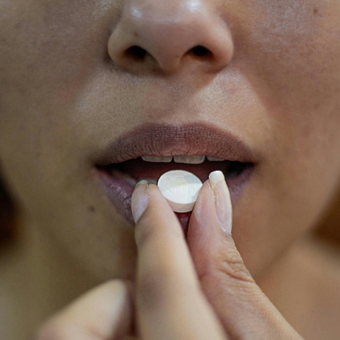 Γυναίκα παίρνει χάπι από στόματος για την ημικρανία