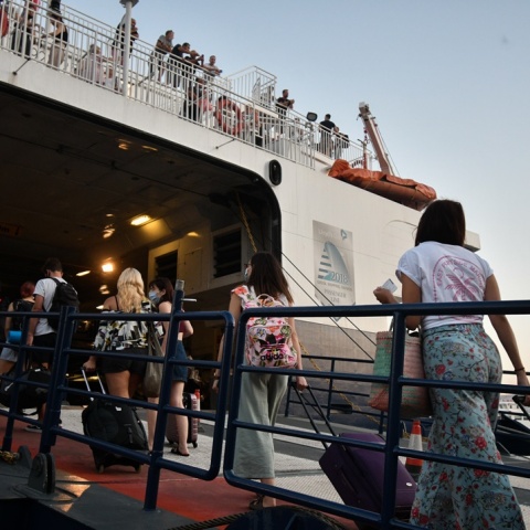 Πολίτες επιβιβάζονται σε πλοίο για τις καλοκαιρινές τους διακοπές