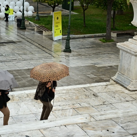 Πολίτες με ομπρέλες στο κέντρο της Αθήνας