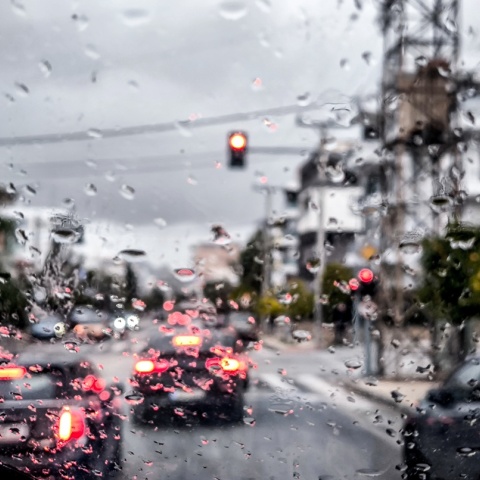 Σταγόνες βροχής στο παρμπρίζ αυτοκίνητου ενώ μέσω καταιγίδας