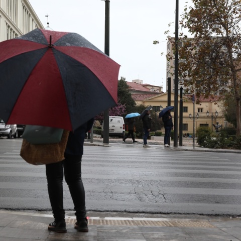 Γυναίκα με ομπρέλα στον δρόμο