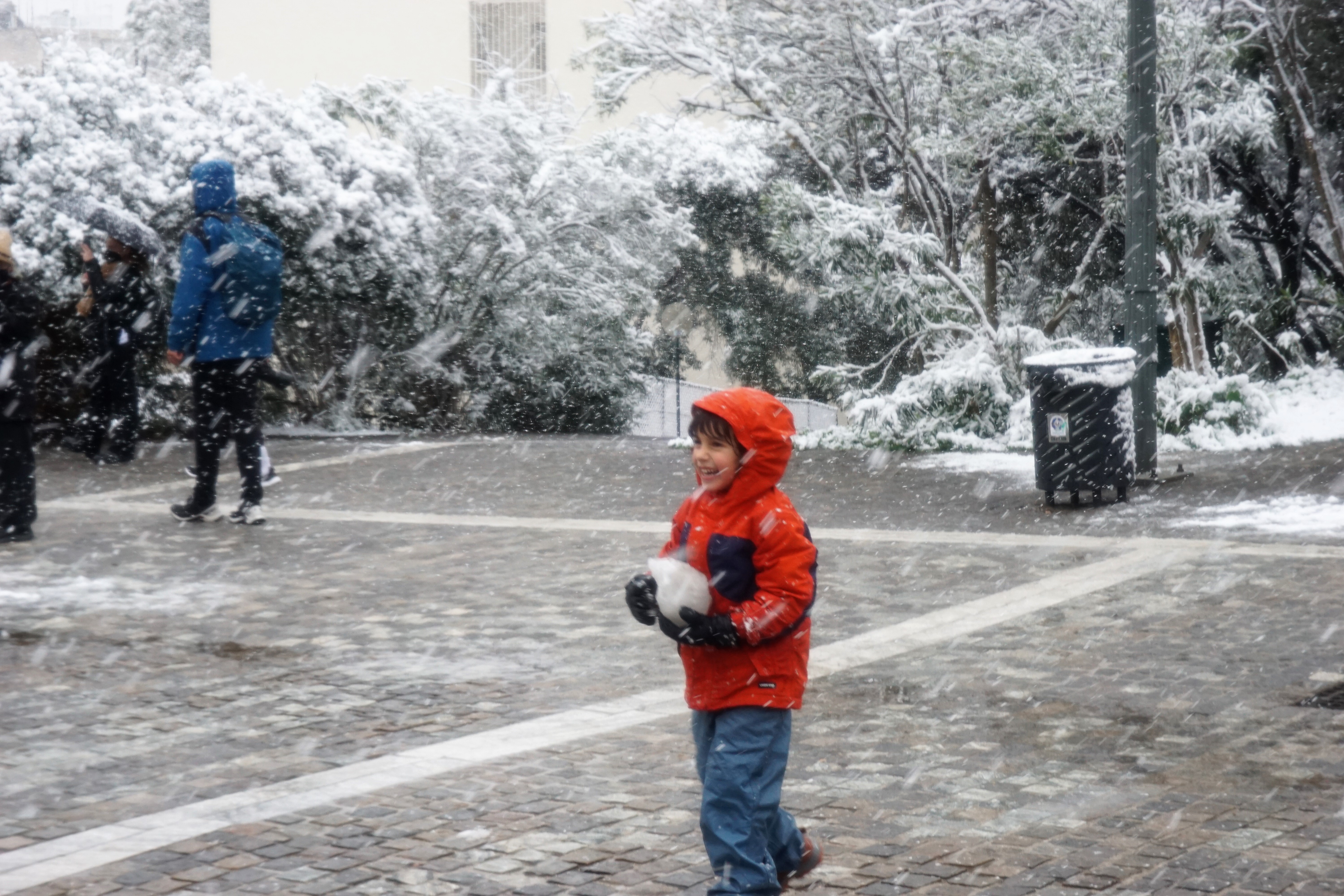 Ένα παιδί παίζει με τα χιόνια. 