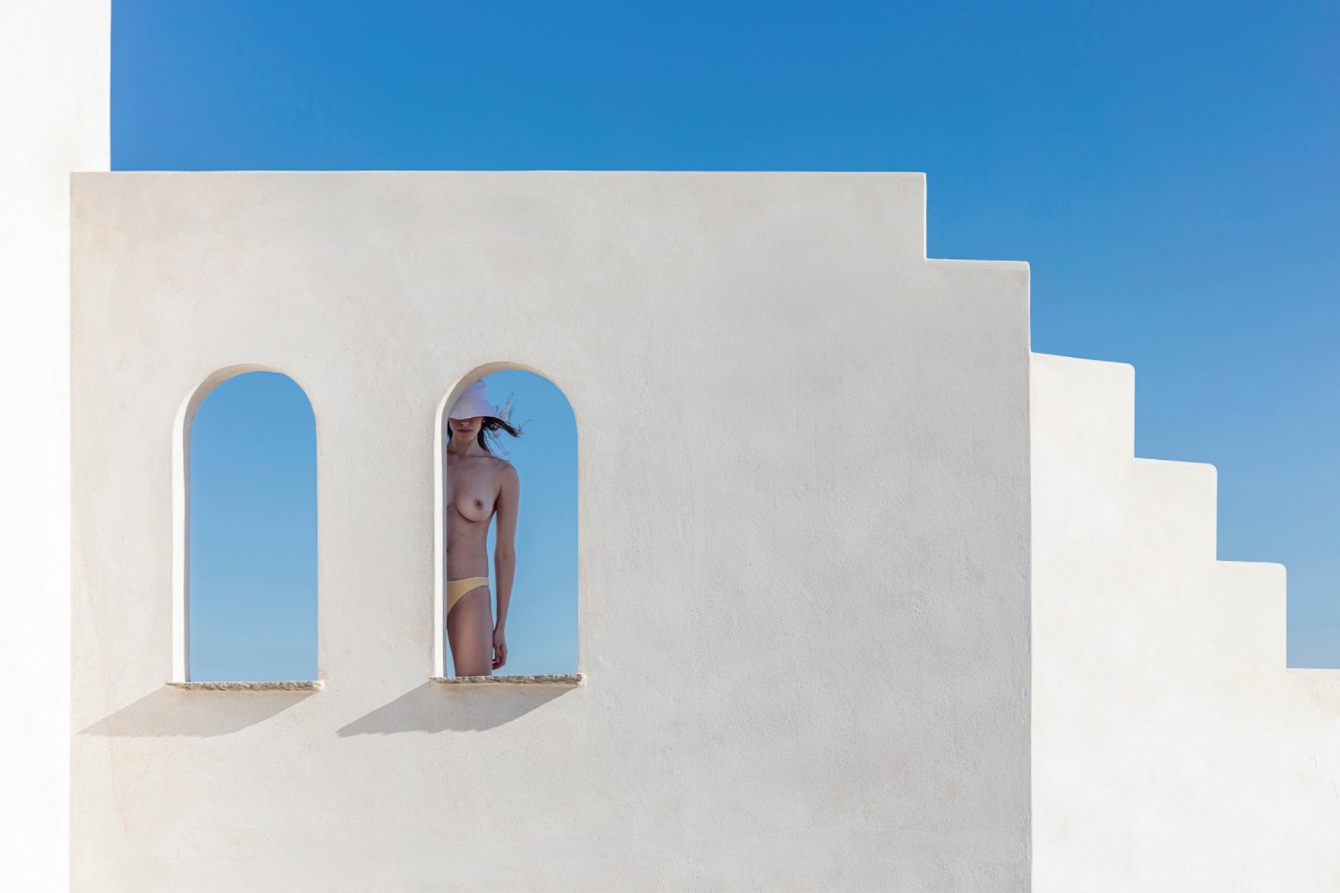 γυναίκα χωρίς μπλούζα με φόντο τη θάλασσα 