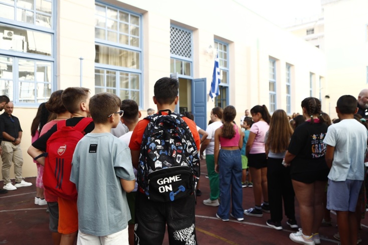 Μαθητές με τις σάκες στους ώμους κατά τη διάρκεια του αγιασμού σε σχολείο