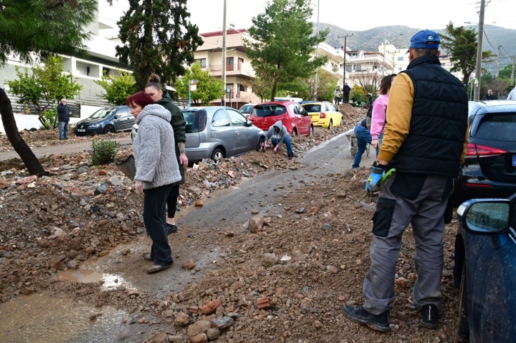 Πολίτες απομακρύνουν πέτρες από τον δρόμο